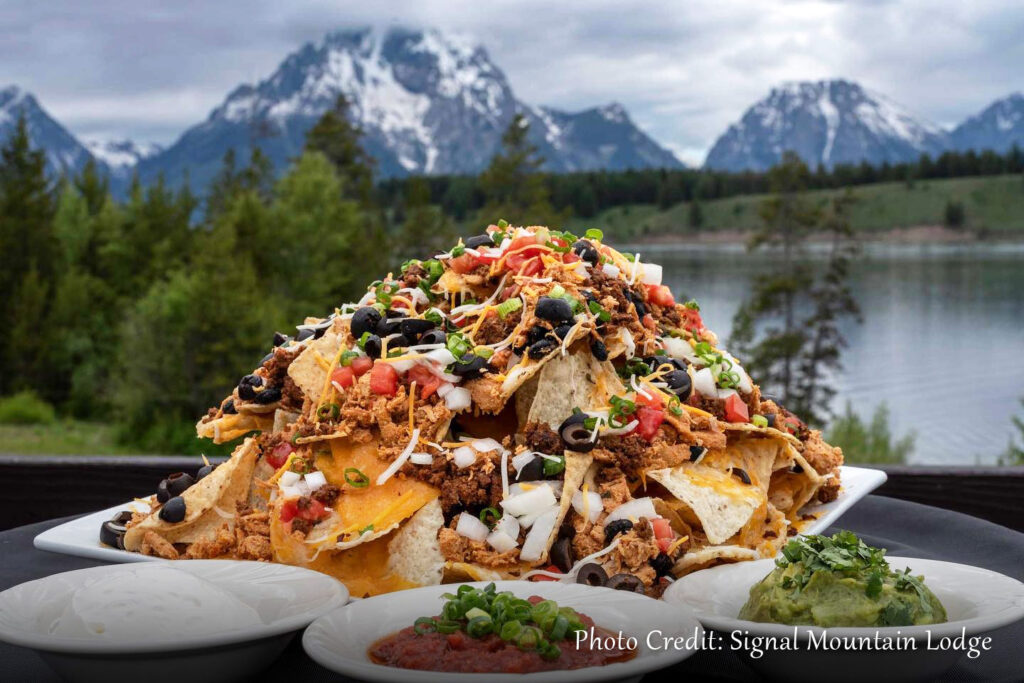 Nachos on the table with mountains in background