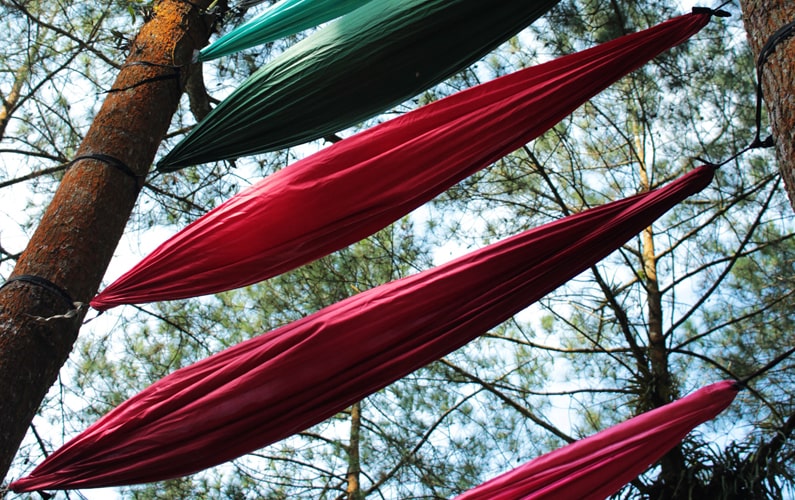 Multiple Hammocks hung stacked on top of one another
