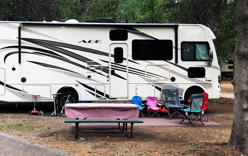 Colter Bay RV Site with RV Parked and Picnic Table in front