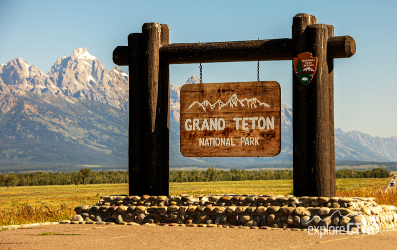 Grand Teton National Park Sign with Grand Teton in background to the left