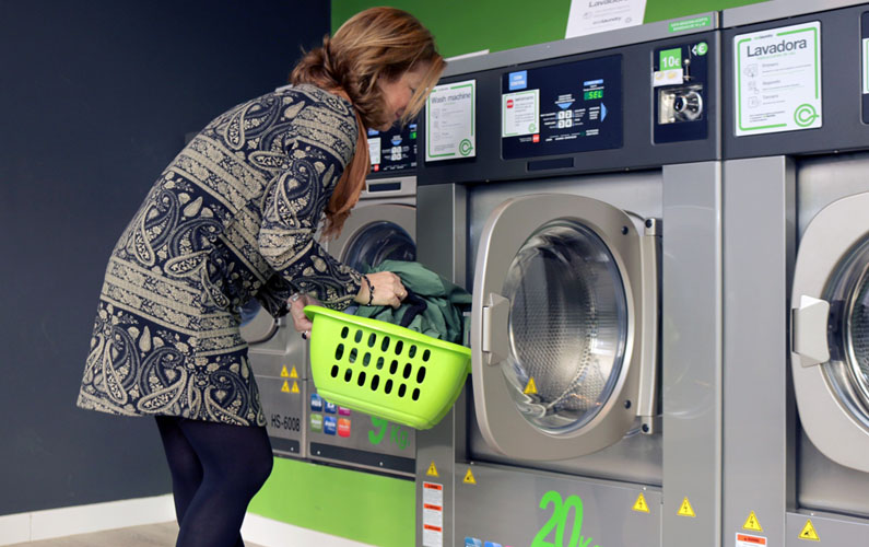 Woman doing laundry at laundromat