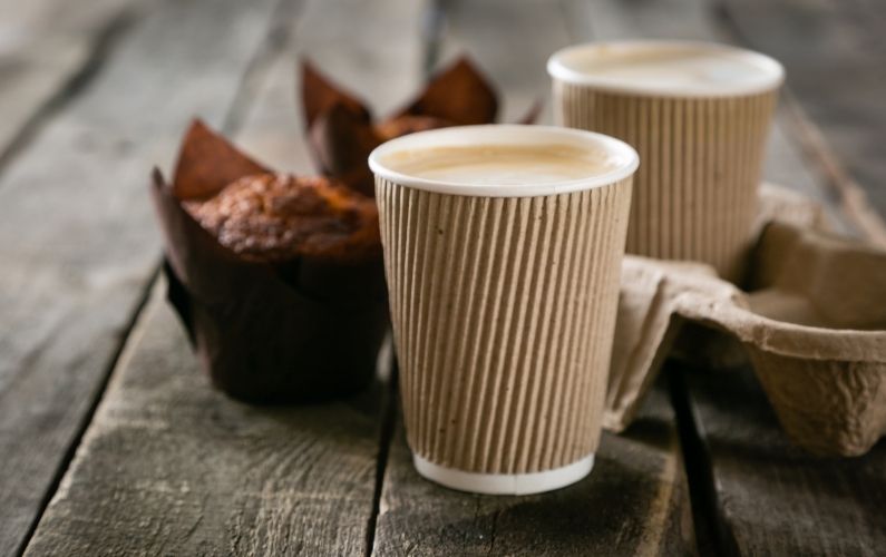 Coffee and muffins on wooden table