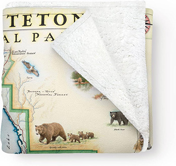 Folded soft blanket with map of Grand Teton National Park on it